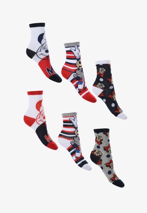 Seis pares de calcetines coloridos con diseños de personajes. Los materiales son suaves, con patrones que incluyen rayas, lunares y caras de personajes.