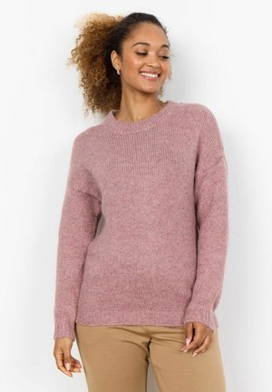 Light pink knitted sweater with a round neck and long sleeves, featuring ribbed cuffs and hem, paired with beige pants. Soft texture.