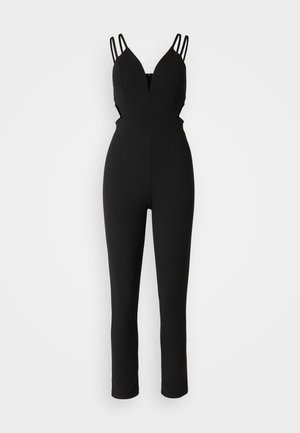 Black jumpsuit with a fitted design, featuring a deep V-neck, thin straps, and cut-out sides. Smooth fabric with a tapered leg.