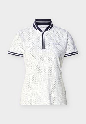 Fehér, rövid ujjú galléros póló kis fekete pöttyökkel, tengerészkék csíkos gallérral és mandzsettával, elöl cipzárral, bal mellrészen Calvin Klein logóval.