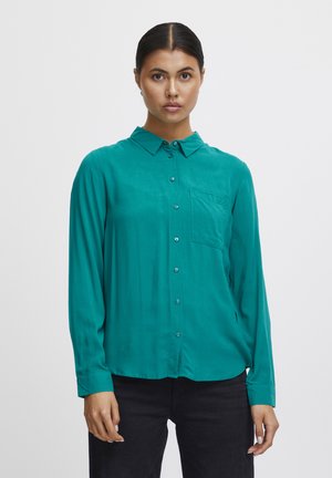Turquoise button-up shirt, lightweight fabric, long sleeves, slight sheen, chest pocket, contrasting buttons, relaxed fit.