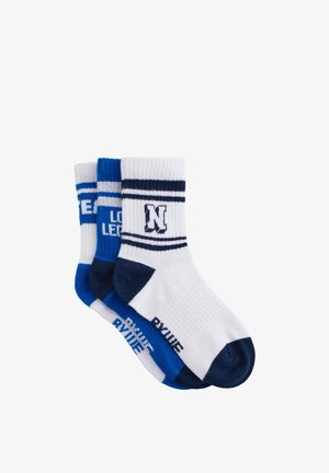 Two pairs of athletic socks in white, blue, and navy. Features ribbed texture, contrasting stripes, and printed logos on the side.