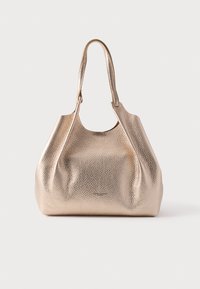 Struktureret skuldertaske i metallisk guldlæder med blød, struktureret form og enkelt remhåndtag mod ensfarvet baggrund.