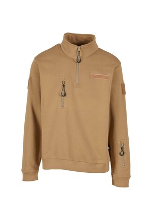 Tan fleece pullover med høj krave, front kvart lynlås og to lynlåslommer. Har et mærke på fronten og en lomme på ærmet.