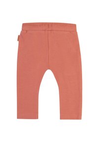 Persikofärgade leggings tillverkade av ett mjukt, elastiskt tyg. Har en slät midjeband och rak skärning med stängda fållar.