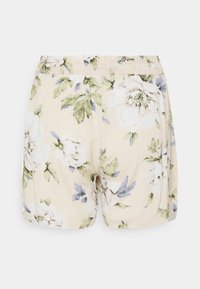 Květinové šortky v světle béžové barvě s jemnou texturou, mají elastický pas a vzor velkých bílých a modrých květin.