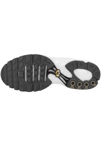 Suola della scarpa con un fondo in gomma nera dal grip testurizzato, forma curva e sei tasche d'aria esposte per l'ammortizzazione.