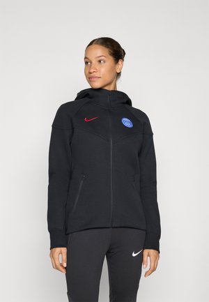 Black zip-up hoodie with a fitted design, featuring a red Nike logo and a blue Paris Saint-Germain emblem. Soft texture, two side pockets.