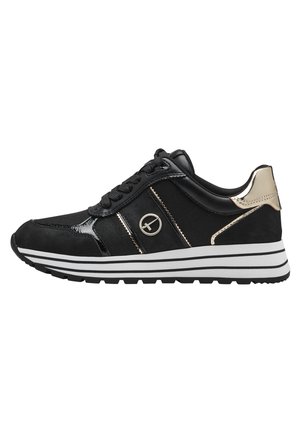 Sort sneaker med hvid stribet sål, metallisk guld hælaccent, snørebånd og cirkulært logo på siden mod en hvid baggrund.