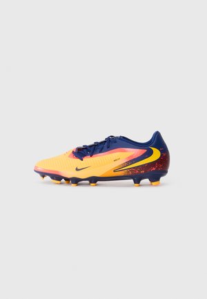 Nike kopačke za nogomet u žutoj i tamnoplavoj boji, s teksturiranim sintetičkim gornjim dijelom, s obrascem gradient završnom obradom, i šestom oblikovanim utezima za prianjanje.