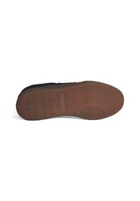 Brown rubber sole of a shoe featuring a textured surface and a patterned tread, with a slight curve at the heel and an indented circular detail.