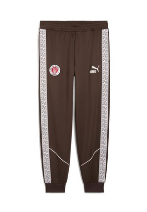Bruine sportbroeken met witte zijkanten die een geometrisch patroon hebben. Inclusief logo's: FC St. Pauli en Puma. Elastische tailleband met boorden.