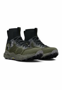 Green and black athletic shoes with a sleek design, textured mesh upper, elastic collar, and rubber outsole featuring prominent traction treads.
