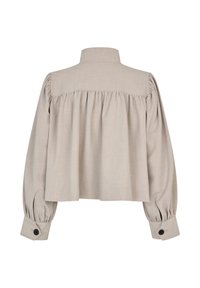 Světle béžová volně střižená blůza s nafukovacími rukávy, zaobleným límcem a zapínáním na knoflíky u manžet. Hladká textura se záhyby na zádech.