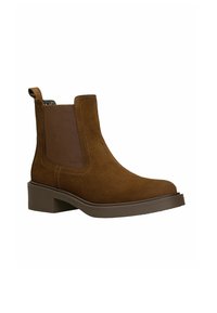 Brązowe zamszowe botki za kostkę z elastycznymi bocznymi panelami i pętlą. Mają okrągły czubek i niski blokowy obcas. Gładka faktura z kontrastującymi szwami.