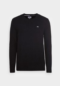 Svart stickad tröja med rund halsringning, ribbade ärmslut och nederkant. Litet logo på bröstet, tillverkad av en texturerad tyg.