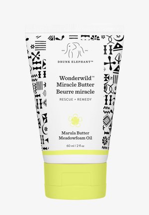 White tube with black geometric patterns, yellow accents, and a flip-top lid. Text includes "Wonderwild Miracle Butter" and ingredients listed.