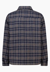 Navy plaid shirt with a soft texture, featuring a collared neckline, button cuffs, and contrasting tan and white grid pattern.