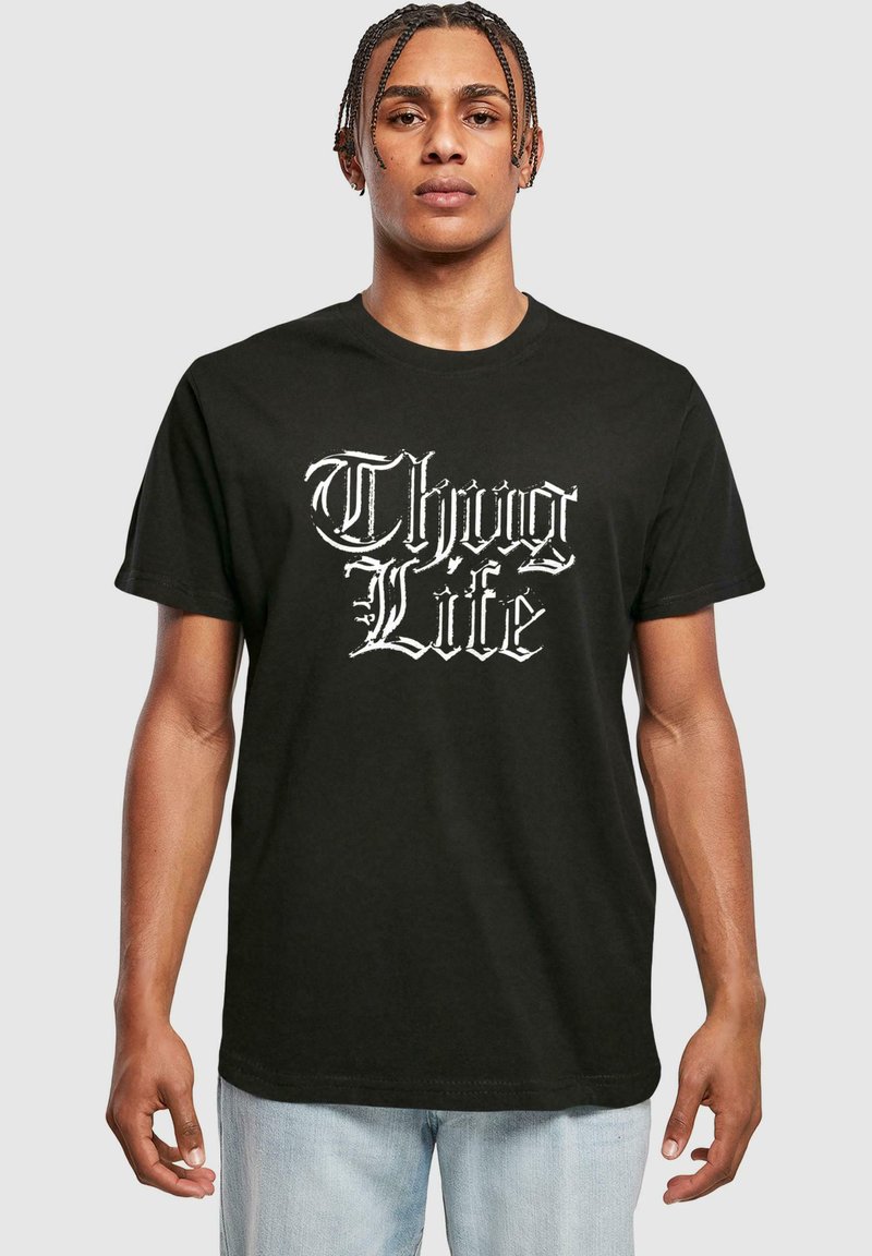 Juodas medvilninis marškinėlis su balta grafika, kurioje užrašyta "Thug Life". Marškinėliai turi trumpas rankoves ir apvalią iškirptę.