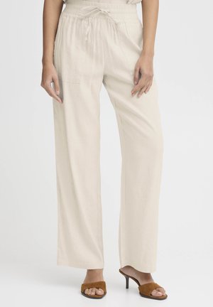 Beżowe spodnie o szerokich nogawkach wykonane z lekkiego materiału, z talią na sznurek, bocznymi kieszeniami i gładką fakturą.