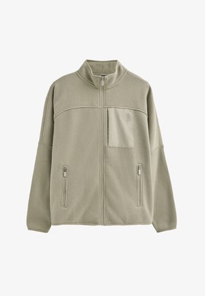 Lichtgroene fleecetruien met hoge kraag, voorrits en twee zijzakken. Beschikt over een horizontale naad en een klein patch pocket.