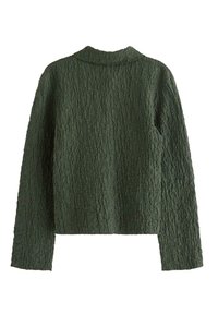 Foldet, mørkegrøn langærmet jakke med krave. Tekstureret stof med et ribbet mønster. Ingen synlige lukninger eller detaljer.