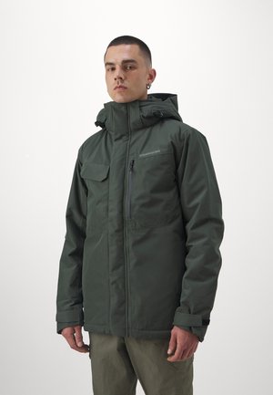 Dark green waterproof jacket with a high collar, adjustable hood, zippered pockets, and a subtle logo on the chest. Features a relaxed fit.