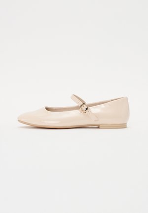 Nude patent leather ballet flats with a rounded toe and a side strap featuring a small gold buckle. Flat rubber sole and smooth texture.