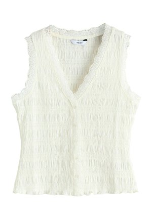 Bluză crem fără mâneci, cu decolteu în V, nasturi în față, margine de dantelă și țesătură texturată cu smock.