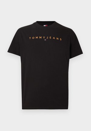 T-shirt noir à manches courtes avec le texte orange « TOMMY JEANS » et un petit logo Tommy Hilfiger rouge, blanc et bleu centré sous le texte.