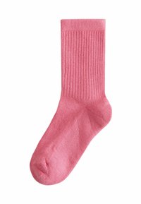 Pink ribbed Baumwollsocke mit mittlerer Schafthöhe, die eine glatte Textur und eine abgerundete Spitze aufweist, entworfen für Komfort und Passform.