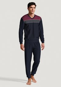 Navy pajama set with a v-neckline, featuring maroon and white striped accents on the chest. Smooth texture, elastic waistband on pants.