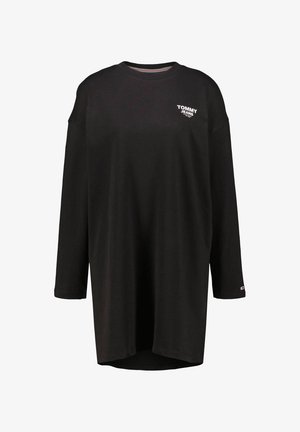 Musta pitkähiha t-paita, valmistettu puuvillasta. Ominaisuuksiin kuuluu pyöreä pääntie, löysä istuvuus ja pieni valkoinen logo vasemmassa rinnassa. Helma on hieman kaartuva.