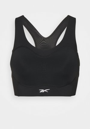 Soutien desportivo preto com costas em malha, copas moldadas e perfurações subtis. Apresenta um logótipo branco na parte da frente. Confeccionado em material elástico.