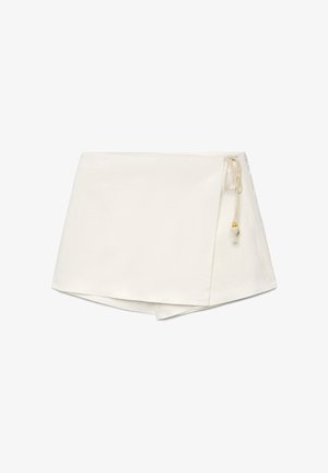 White wrap skirt with asymmetrical hem and beige drawstring tie featuring small wooden beads on a white background.