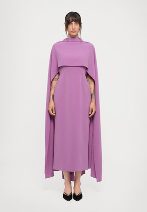 Long purple dress with a wide, draping cape-like top, smooth texture, and a floor-length silhouette. Black shoes complete the look.