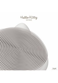 Hello Kitty ansiktsborste med mjuka silikonborst, rund form och vit färg. Texturerad yta med upphöjda prickar och vågiga mönster.