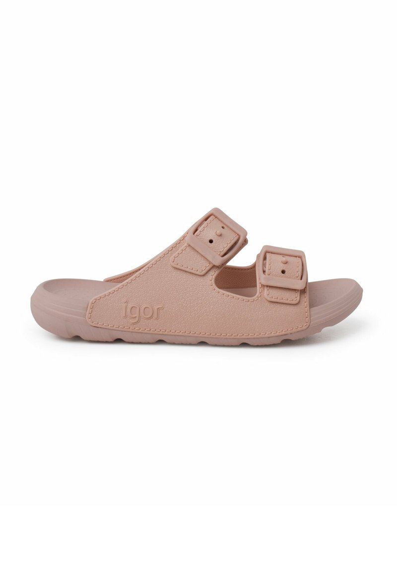 Sandal de goma rosa claro con la punta abierta, dos correas ajustables y una superficie texturizada. Presenta el nombre de la marca "igor" grabado en el lateral.