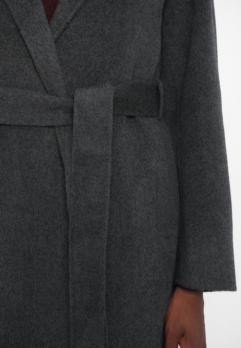Gray wool coat with a textured finish, belted waist, and wide sleeves. The fabric appears soft and warm, featuring no visible patterns.