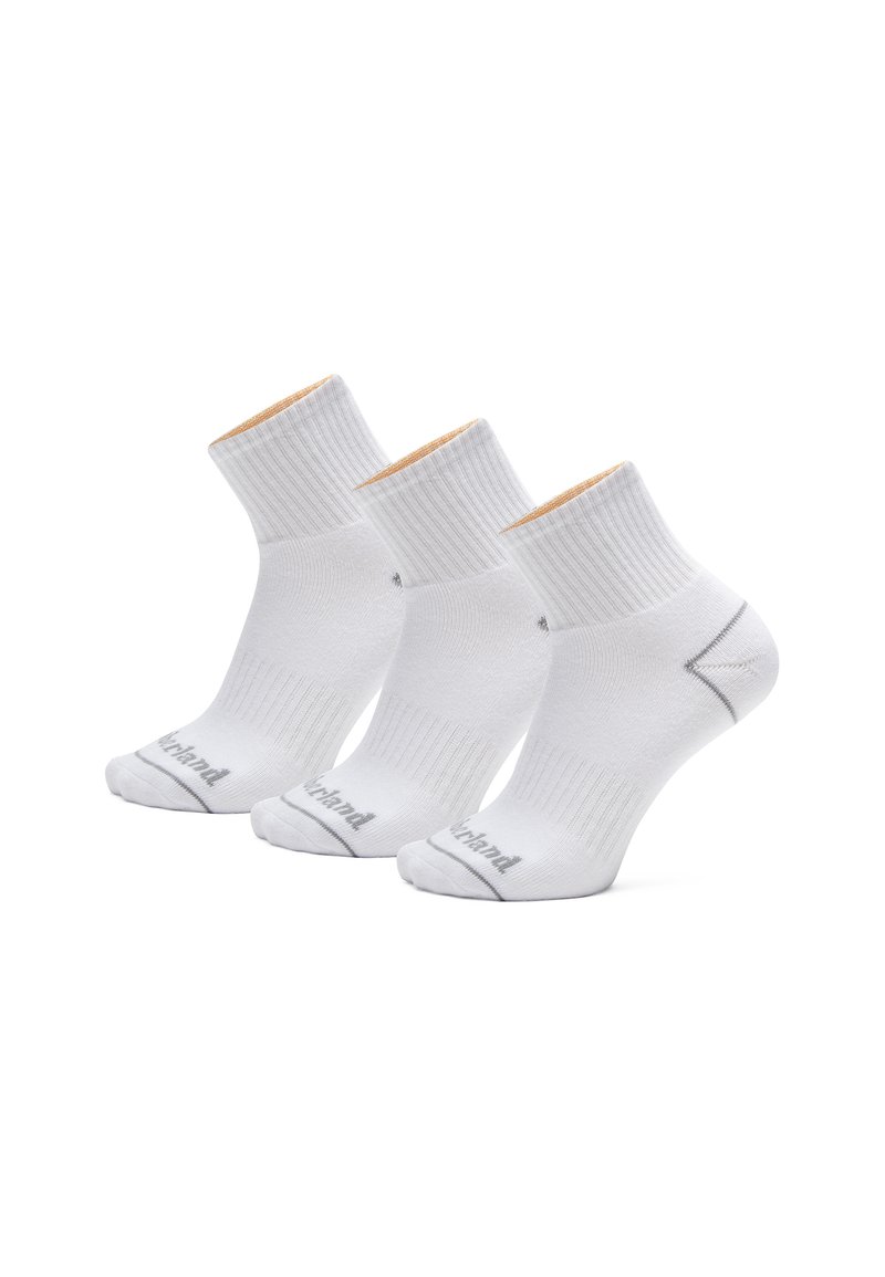 Bílé kotníkové ponožky s ribovanou strukturou, s kontrastním tan rukávem a šedým logem na špičce. Balení obsahuje tři páry.