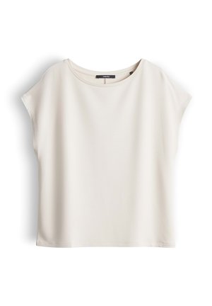 Blusa crema semplice a maniche corte con scollo rotondo e taglio ampio, mostrata distesa su uno sfondo bianco.