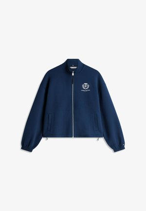 Marineblaue Reißverschlussjacke mit elastischen Bündchen, zwei Vorderentaschen und weißem Tommy Hilfiger-Logo auf der linken Brust.