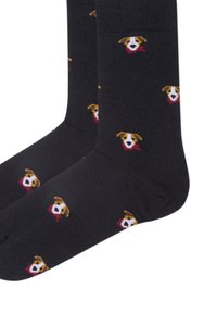 Mørke sokker med gentagne små hundeansigt, der bærer r�øde tørklæder, som mønsteret på stoffet.