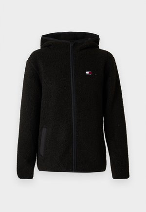 Veste polaire noire zippée avec capuche, deux poches latérales et un petit logo Tommy Jeans sur la poitrine gauche.