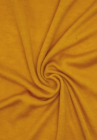 Jasnożółta dzianina, miękka w dotyku, o gładkiej powierzchni, z wirującym wzorem, lekka i elastyczna, o lekko melanżowym wyglądzie.