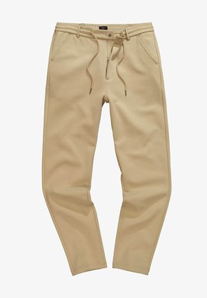 Pantaloni jogger beige realizzati in tessuto morbido, con vita elasticizzata e cordini, tasche laterali e taglio affusolato.