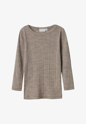 Beige ribade kangaste pikkade varrukatega särk. Omab ümmargust kaelust ja sirget lõiget. Pehme tekstuur, millel on silmatorkavad vertikaalsed jooned.