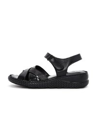 Sandal in pelle nera con cinturini incrociati, cinturino alla caviglia regolabile, suola testurizzata e bordatura intrecciata. Piattaforma bassa per il comfort.