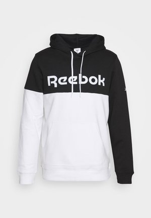 Zwart-witte Reebok hoodie met voorzak, capuchon met witte trekkoorden en de merknaam gedrukt op de borst.