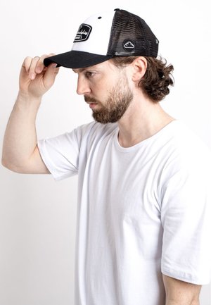 Trucker hat with a black mesh back and white front, featuring a black rectangular patch logo, curved brim, and adjustable snapback closure.